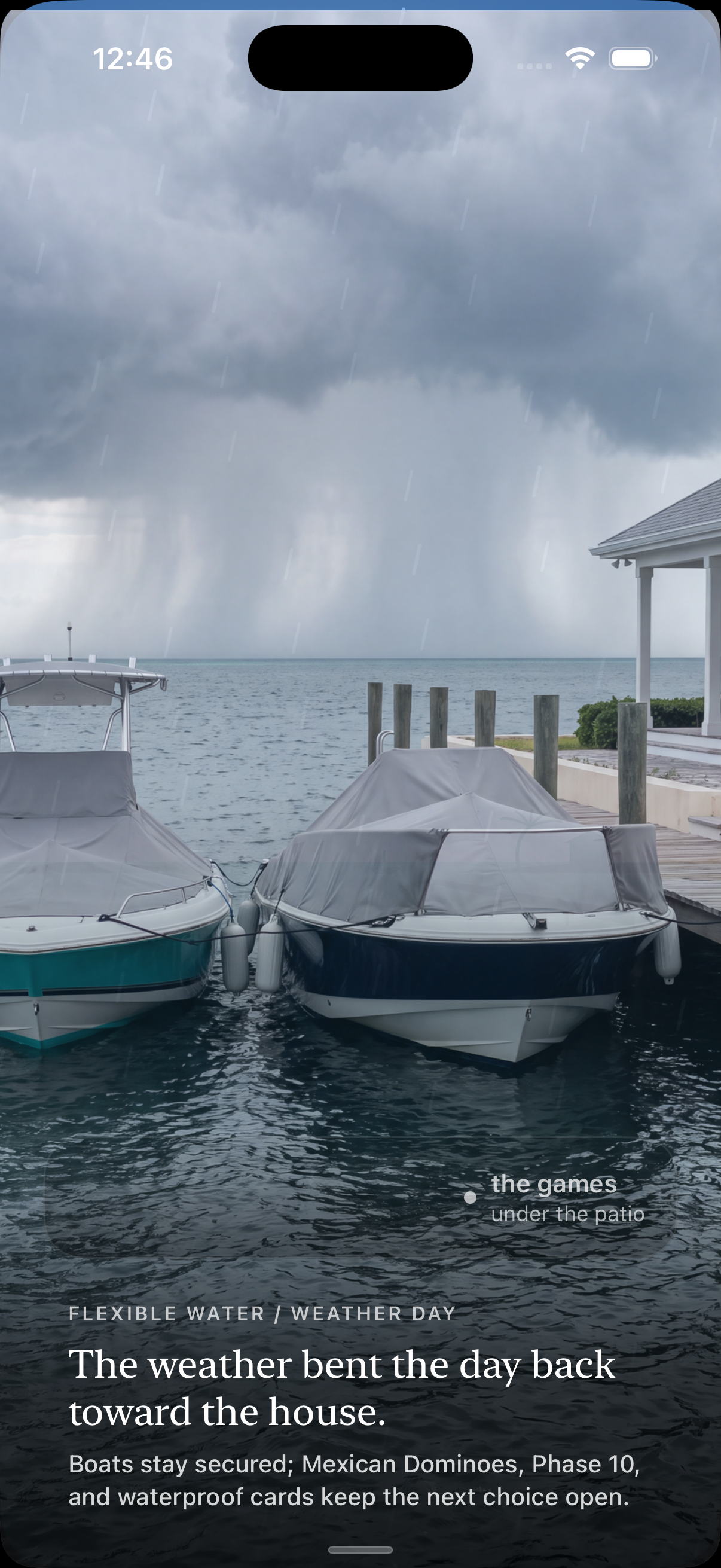 VacationOS rain delay: both boats covered and secured at the dock while a rain column moves across the water, noting the games under the patio.